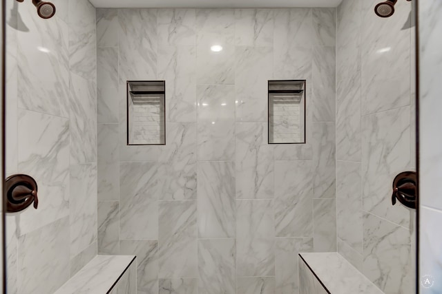 bathroom featuring a tile shower