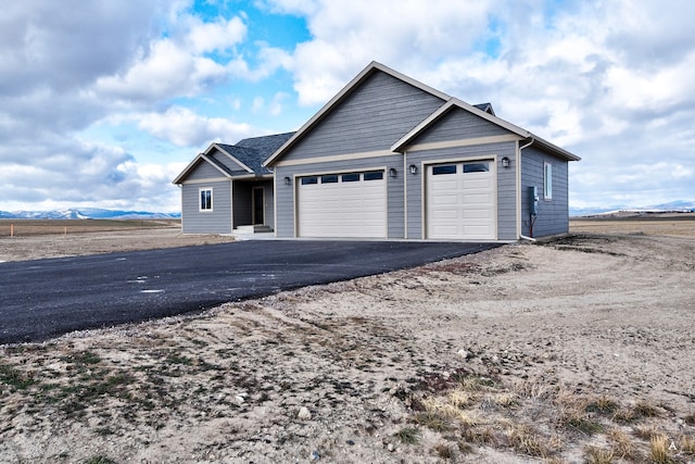 view of front of house featuring a mountain view and a garage