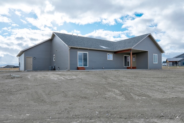 rear view of property with central AC unit