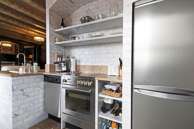 kitchen with tasteful backsplash and appliances with stainless steel finishes