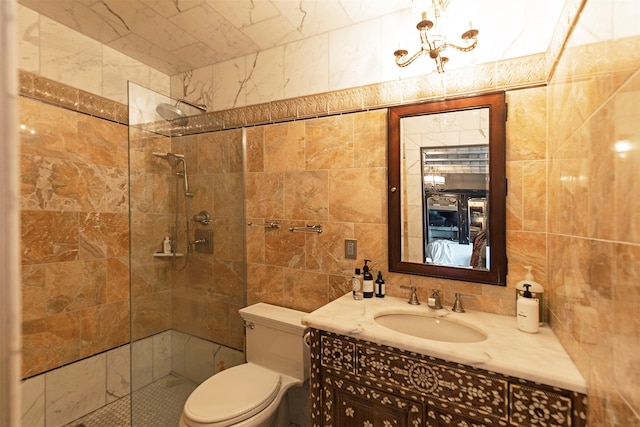 bathroom with vanity, a shower with door, toilet, and tile walls