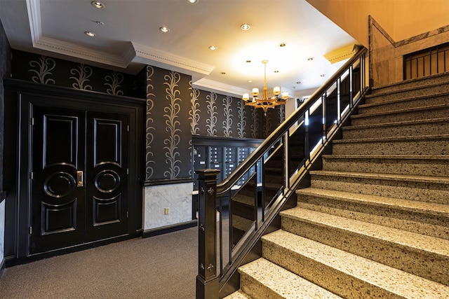 stairs with carpet flooring, crown molding, and a chandelier