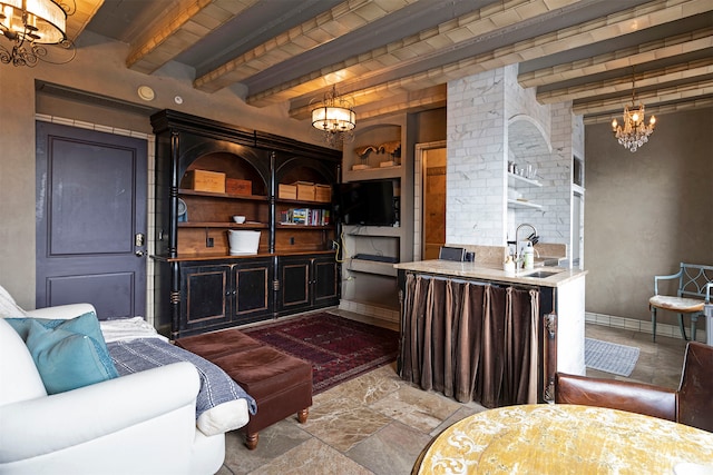 interior space with beamed ceiling, a chandelier, and sink