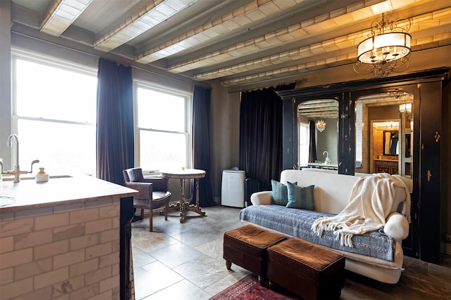 living room with a notable chandelier, beam ceiling, and wooden ceiling