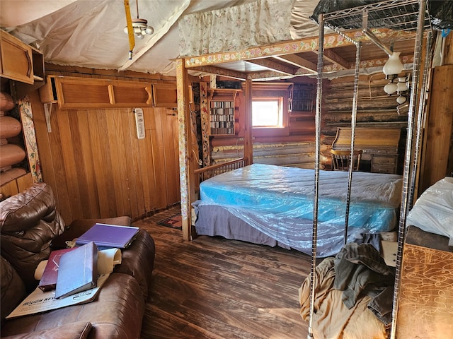 bedroom with wood-type flooring and log walls