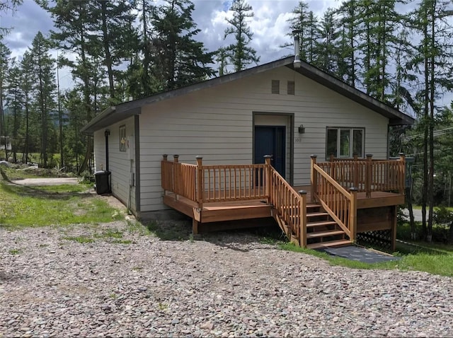 back of house featuring a wooden deck