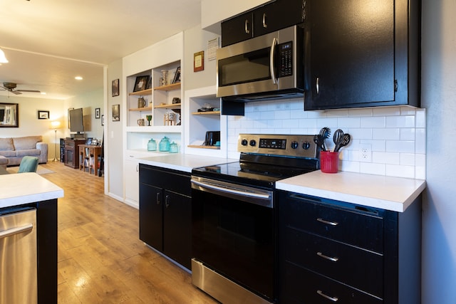 kitchen featuring appliances with stainless steel finishes, backsplash, light hardwood / wood-style flooring, and ceiling fan