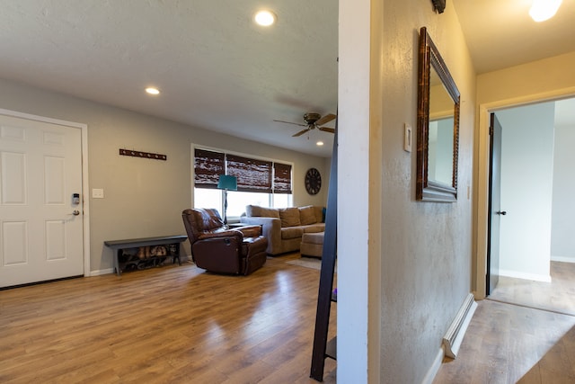 interior space featuring wood-type flooring and ceiling fan