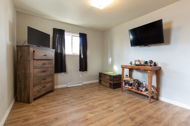 bedroom featuring light hardwood / wood-style floors and multiple windows