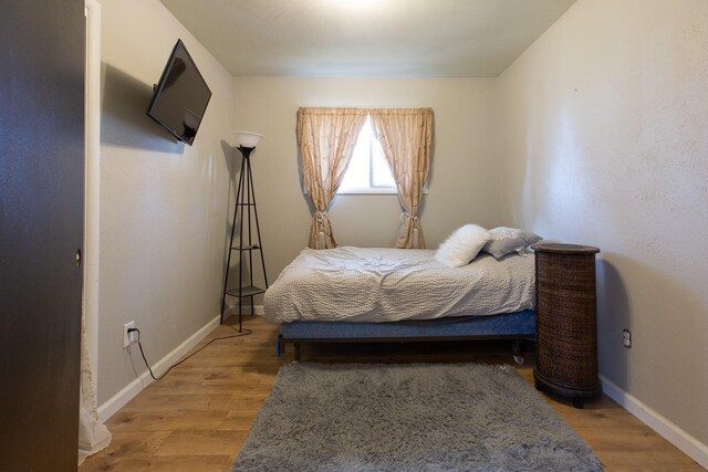 bedroom featuring light wood-type flooring and a closet