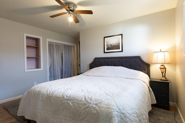 bedroom with ceiling fan, dark hardwood / wood-style floors, and a closet