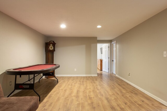 corridor with light hardwood / wood-style floors and a textured ceiling