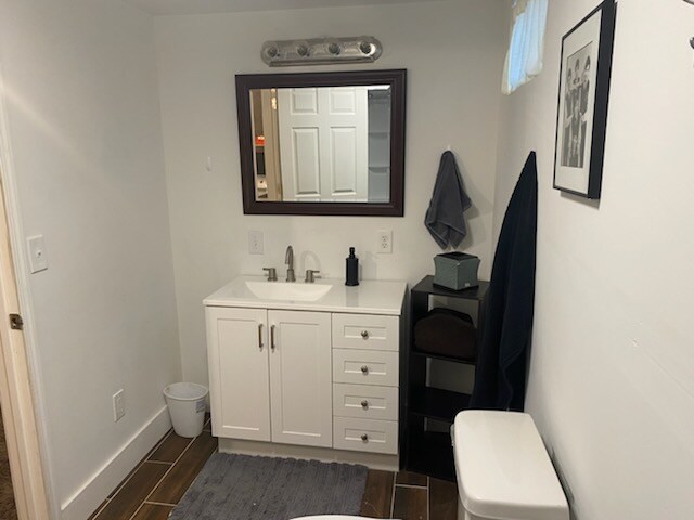 bedroom with light hardwood / wood-style floors and multiple windows