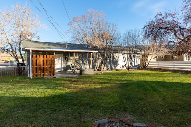 rear view of house with a lawn and a patio area