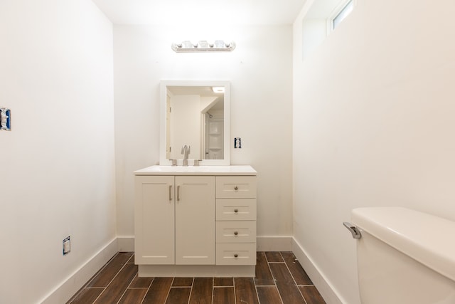 bathroom featuring hardwood / wood-style floors, vanity, and toilet