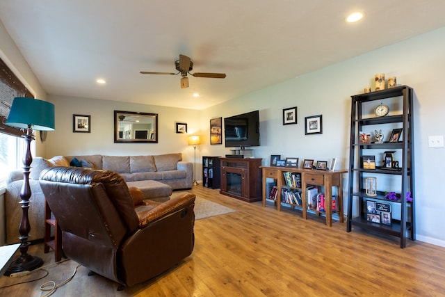 living room with hardwood / wood-style floors and ceiling fan