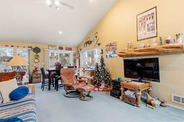 living room with carpet flooring, high vaulted ceiling, and ceiling fan