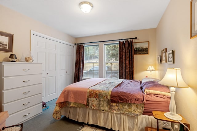 bedroom with dark carpet and a closet