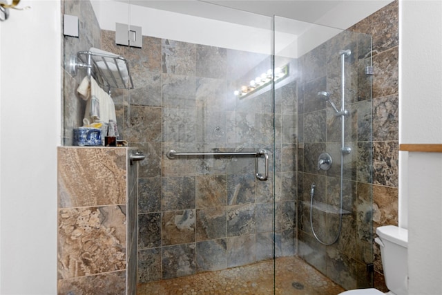 bathroom featuring walk in shower and toilet