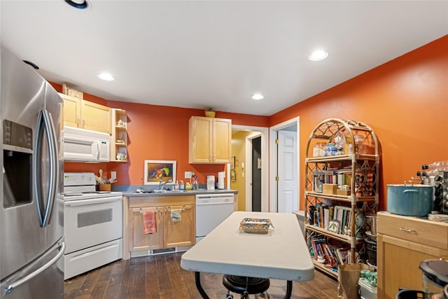 kitchen with light brown cabinets, white appliances, dark hardwood / wood-style floors, and sink