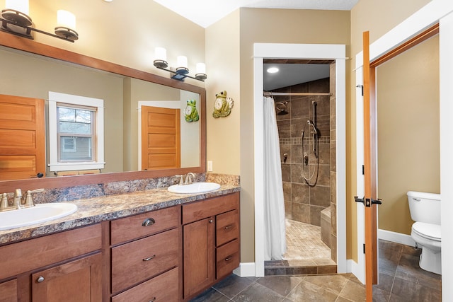 bathroom featuring toilet, walk in shower, and vanity