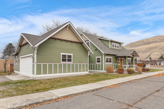 view of front of house with a front yard and a garage