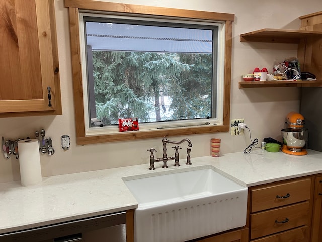 kitchen featuring stainless steel dishwasher, a wealth of natural light, and sink