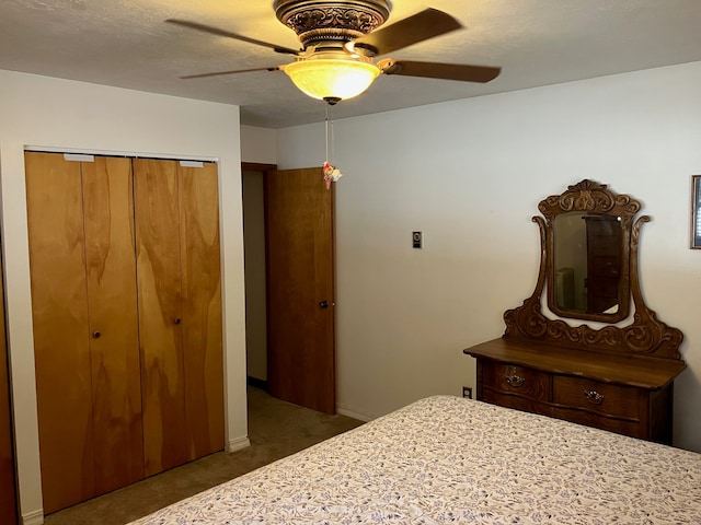 bedroom featuring ceiling fan, a closet, and dark colored carpet