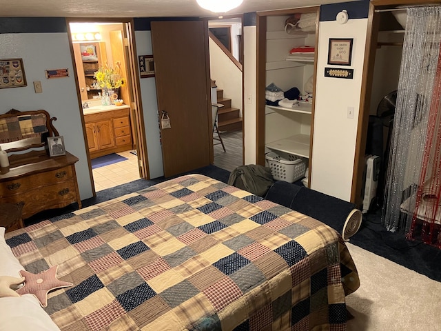 carpeted bedroom with connected bathroom and a closet