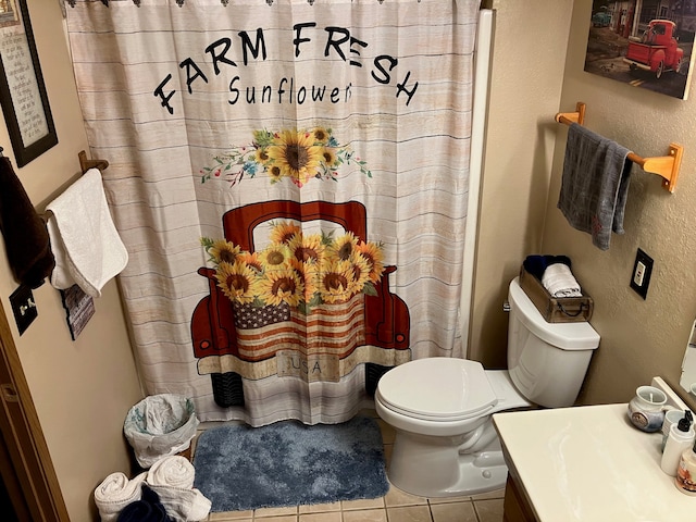 bathroom with tile patterned flooring, vanity, a shower with shower curtain, and toilet