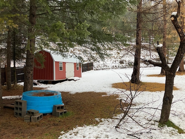 snowy yard with a storage unit