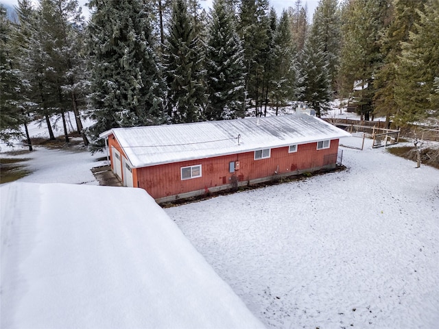 view of snowy exterior with an outdoor structure