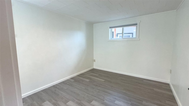 unfurnished room with dark hardwood / wood-style flooring