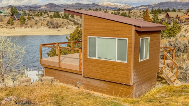 view of side of property featuring a water and mountain view