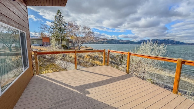 wooden deck featuring a water and mountain view