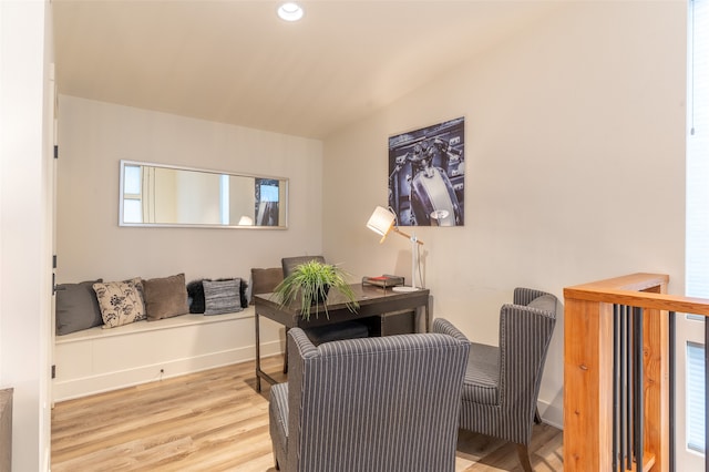 home office featuring vaulted ceiling and light hardwood / wood-style flooring