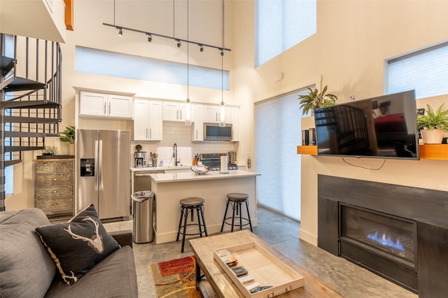 living room with a high ceiling and sink