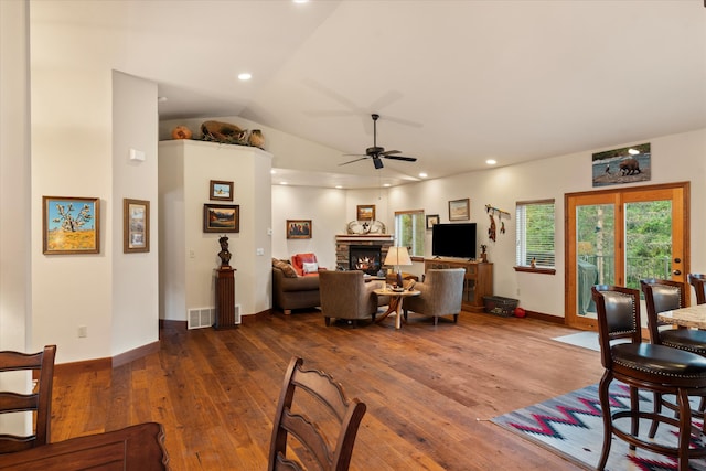 living room featuring a fireplace, dark hardwood / wood-style flooring, ceiling fan, and lofted ceiling