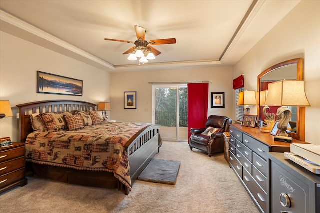 carpeted bedroom with ceiling fan, a raised ceiling, crown molding, and access to outside