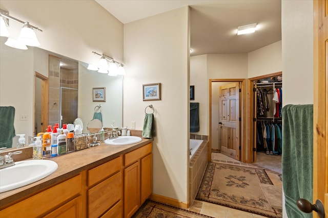 bathroom featuring vanity and tiled bath