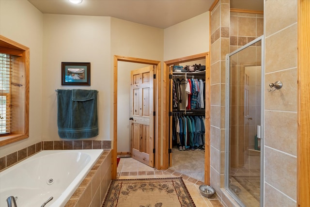 bathroom featuring tile patterned flooring and independent shower and bath