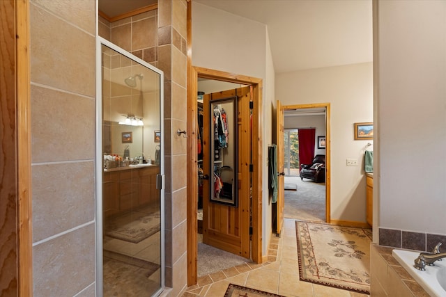 bathroom featuring plus walk in shower and tile patterned floors