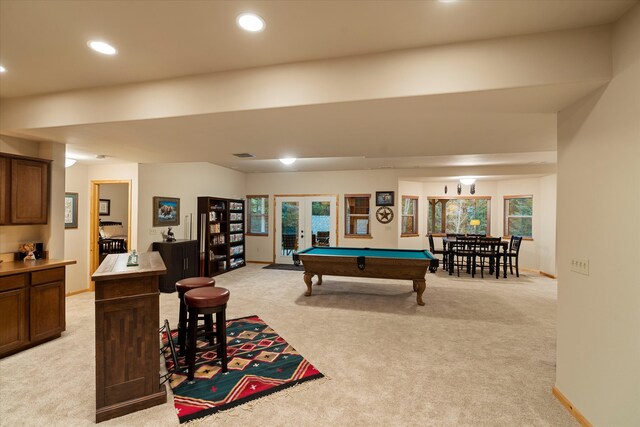 game room with light colored carpet, billiards, and french doors