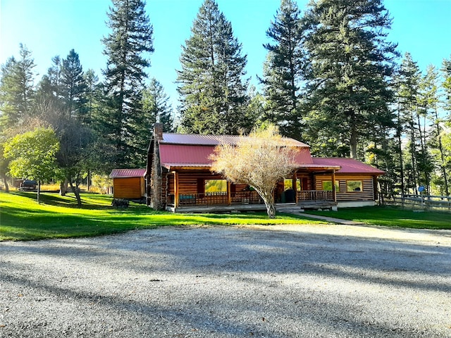 log home featuring a front lawn