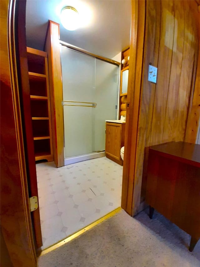 bathroom featuring an enclosed shower and toilet