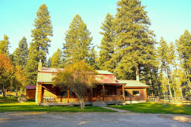 log cabin with a front yard