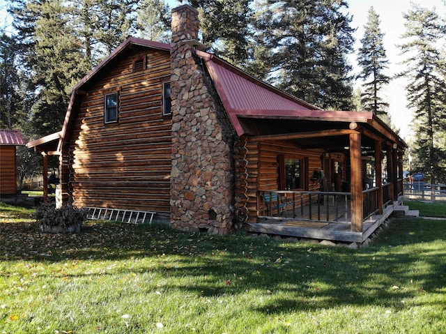 view of property exterior featuring covered porch and a lawn