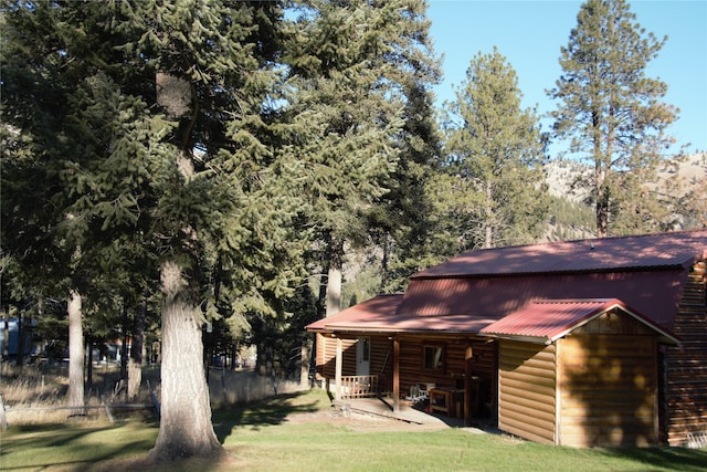 rear view of property featuring a yard