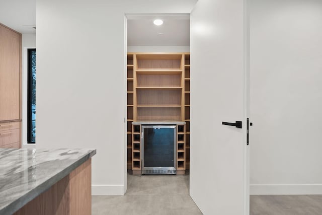 walk in closet featuring indoor bar and beverage cooler