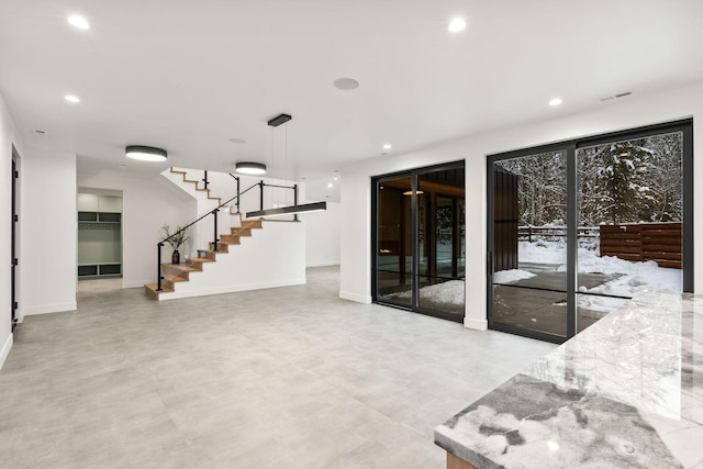 1027 State Park Rd, Whitefish, MT 59937 - unfurnished living room featuring stairs, recessed lighting, and concrete floors